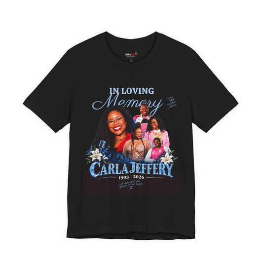 A black short-sleeve t-shirt with a large personalized memorial graphic on the front. The graphic features a photo collage of a woman named Carla Jeffery with her family, blue script text reading 'IN LOVING Memory', and 'CARLA JEFFERY 1993 - 2026' in blue.